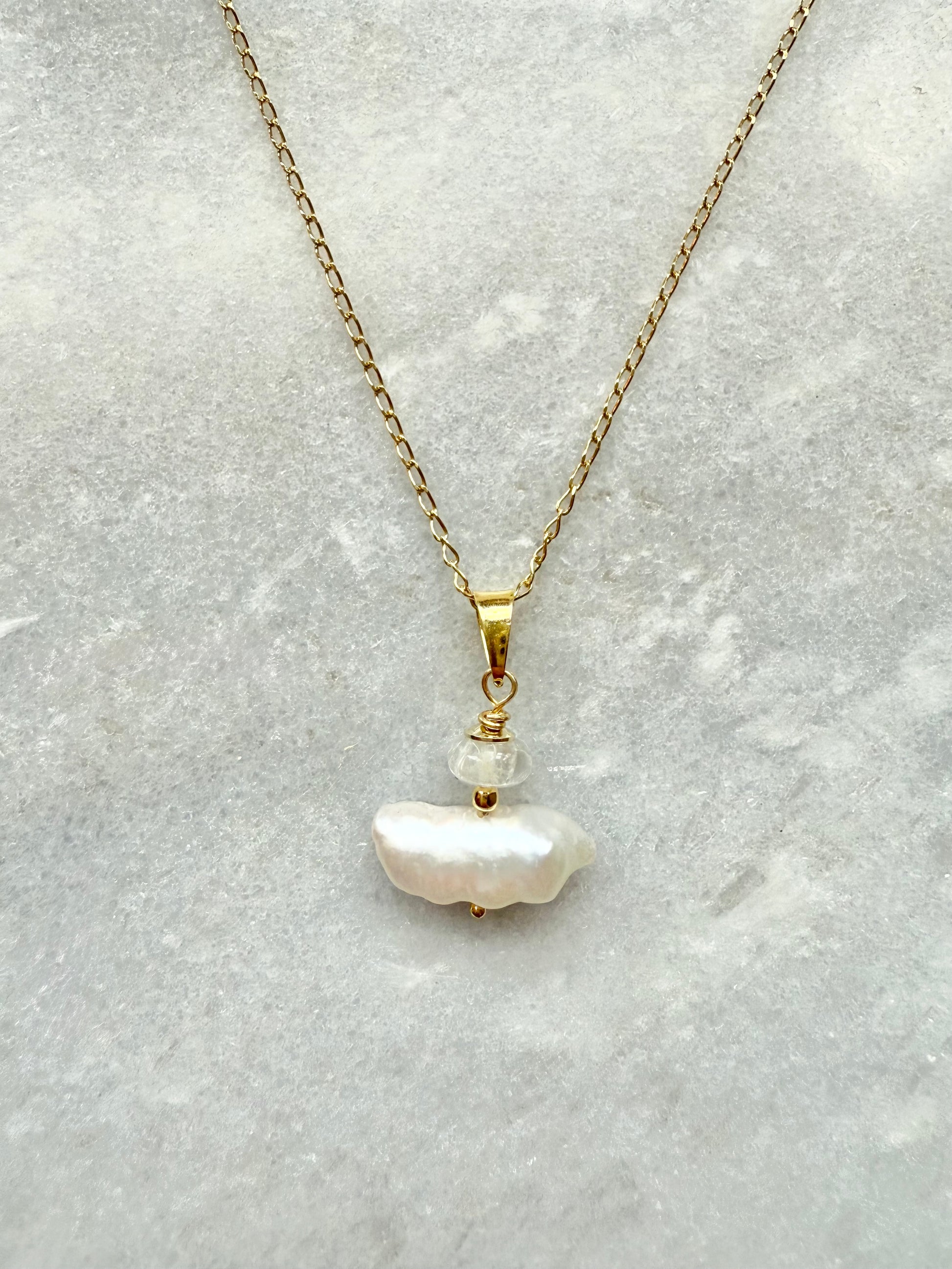Elegant pendant necklace featuring Biwa pearl and a shimmering moonstone, both set on a delicate gołd vermeil chain.