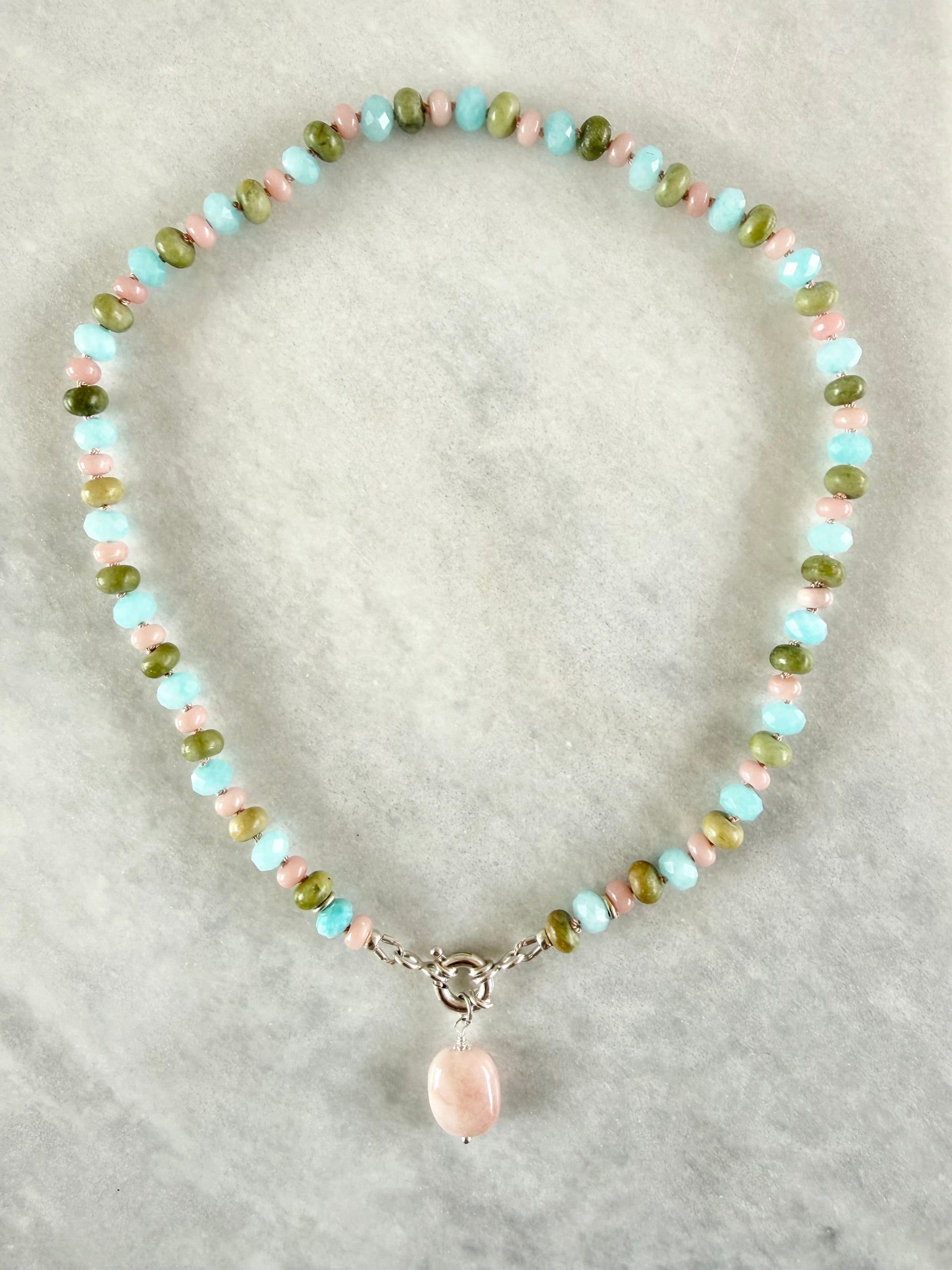 Hand knotted gemstone necklace with a pink pendant and sterling silver sailor clasp