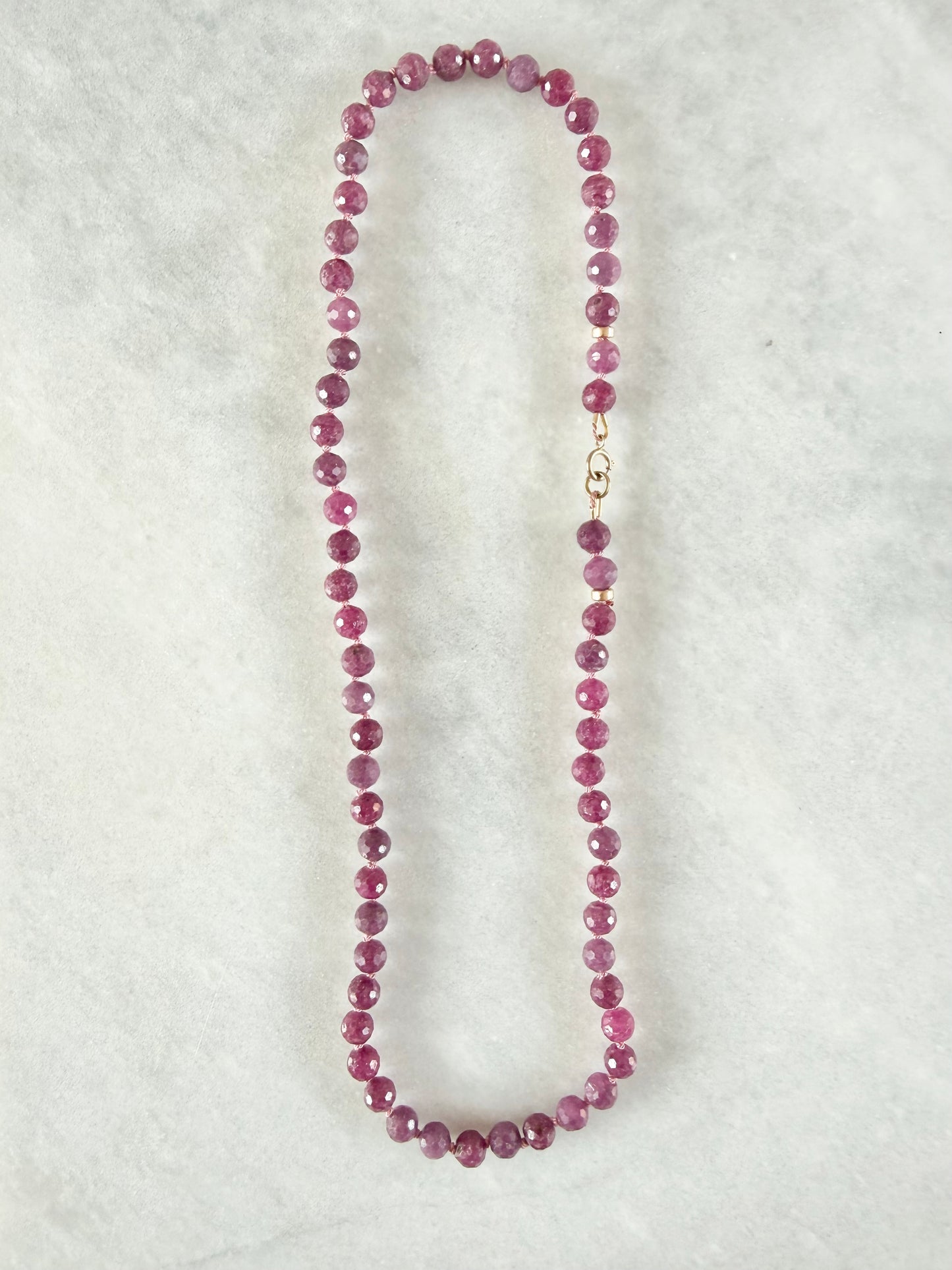 Necklace with pink beads on a white background