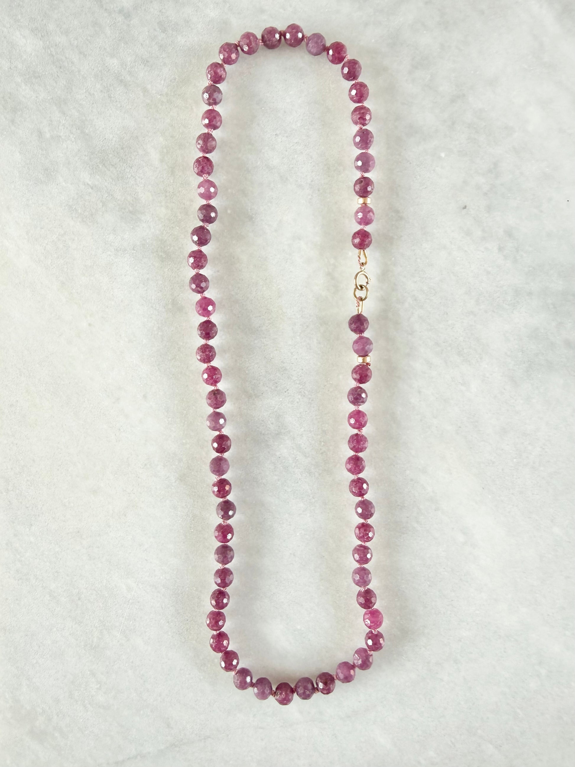 Necklace with pink beads on a white background